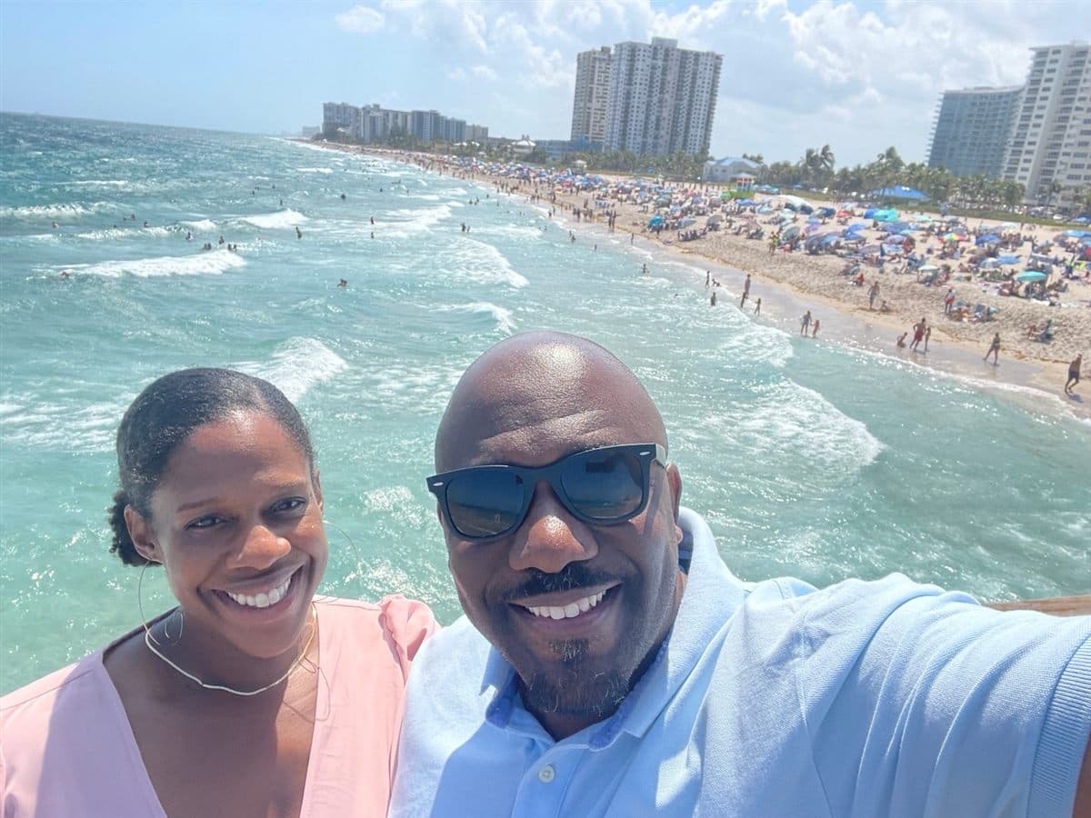 Garaudy Joseph and his wife on a pier above a South Florida beach