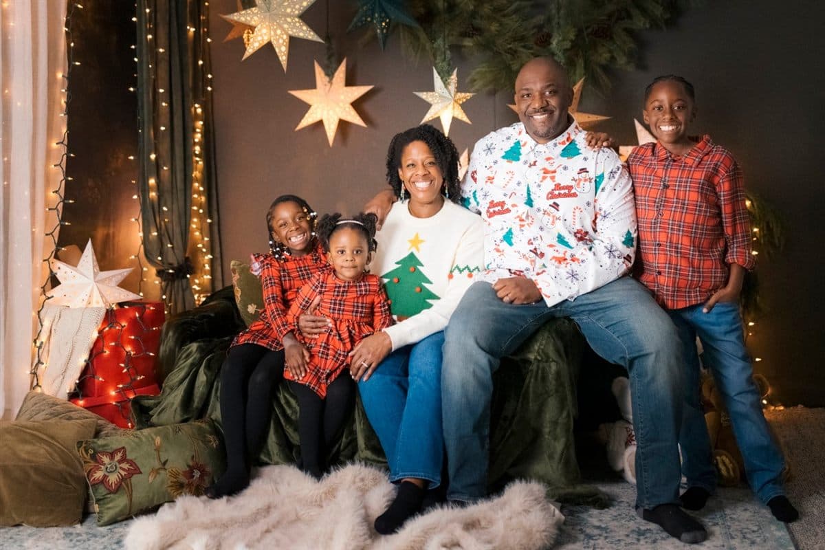 Garaudy Joseph with his wife and three children in a holiday family portrait
